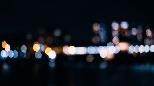 Free Artistic bokeh effect showcasing colorful city lights against a dark night sky. Stock Photo