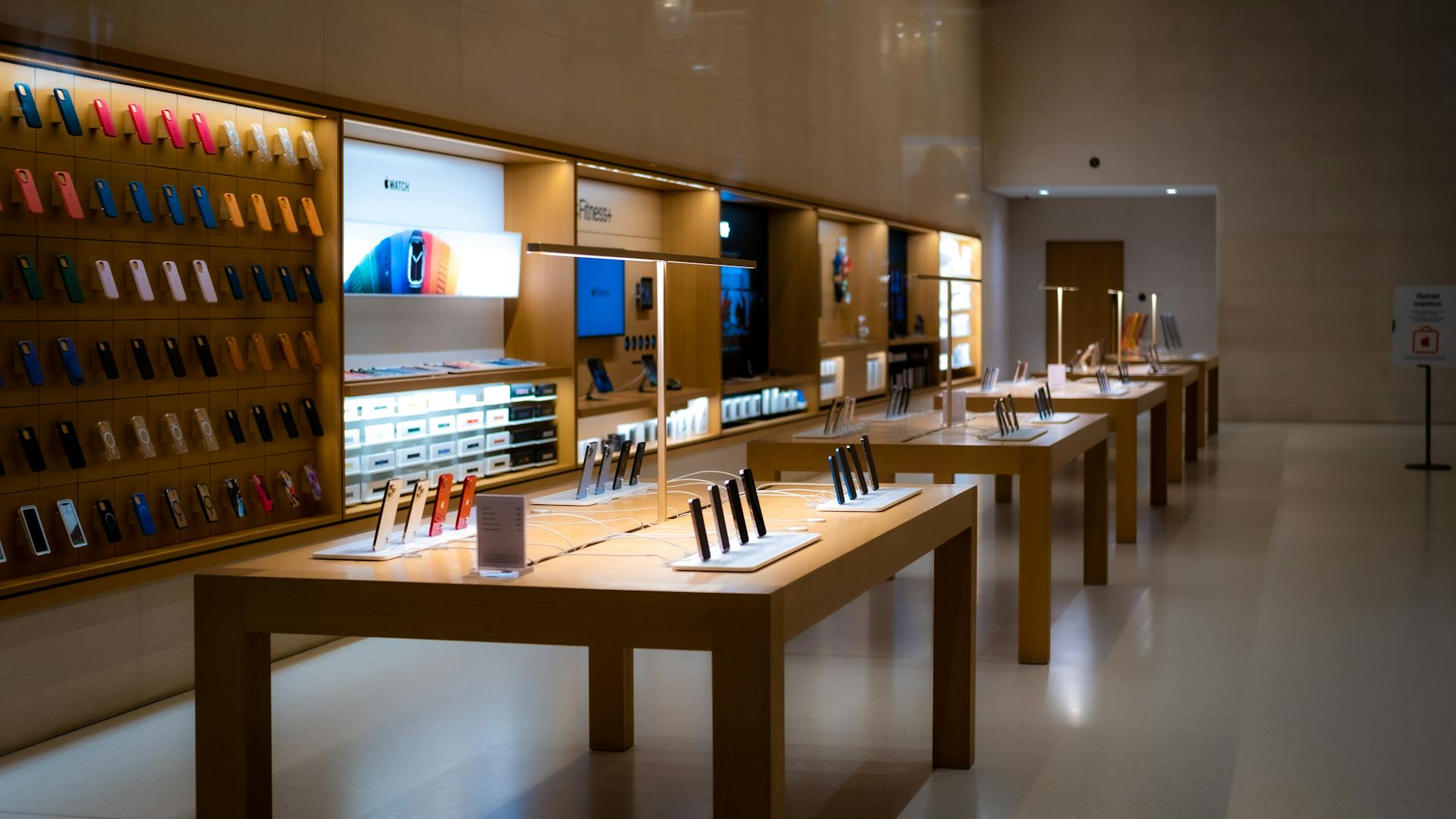 Sleek interior of a high-tech store showcasing various mobile devices and accessories.