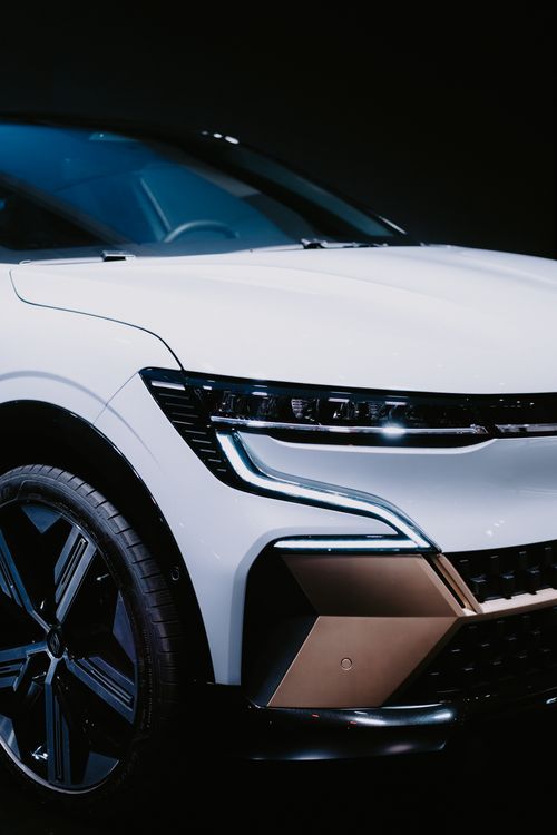 Free Front view close-up of a sleek white car with chrome accents. Luxury and style. Stock Photo