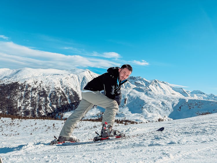 Man Skiing On Snow Covered Mountain Area