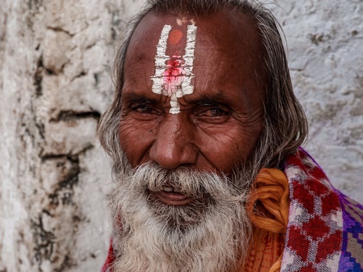 Smiling Elderly Man With Symbol On Forehead