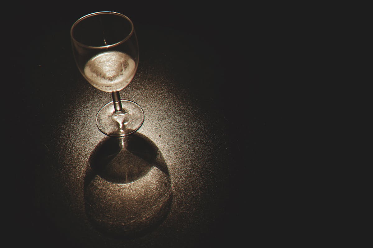 Clear Wine Glass on Black Surface