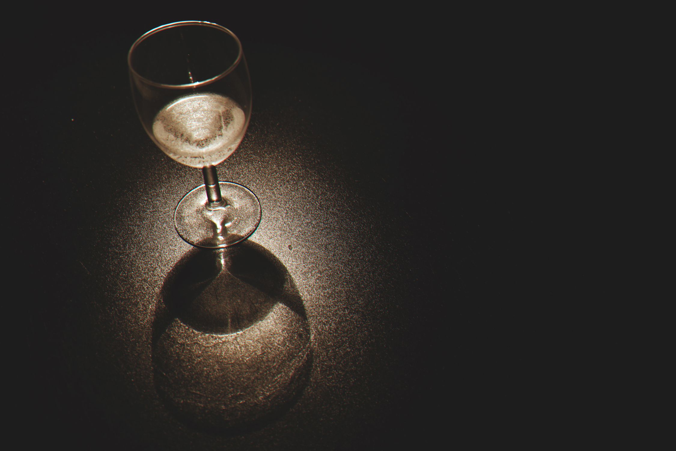 Clear Wine Glass on Black Surface
