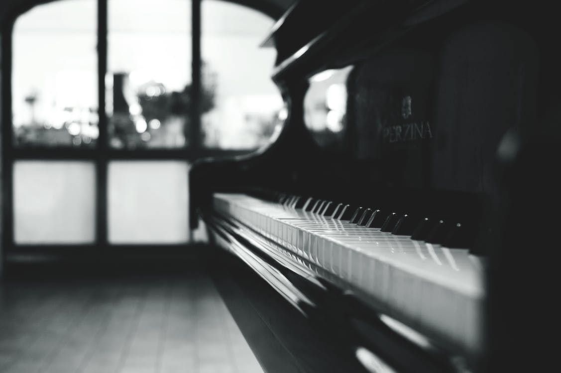 Black grand piano in the grayscale photo