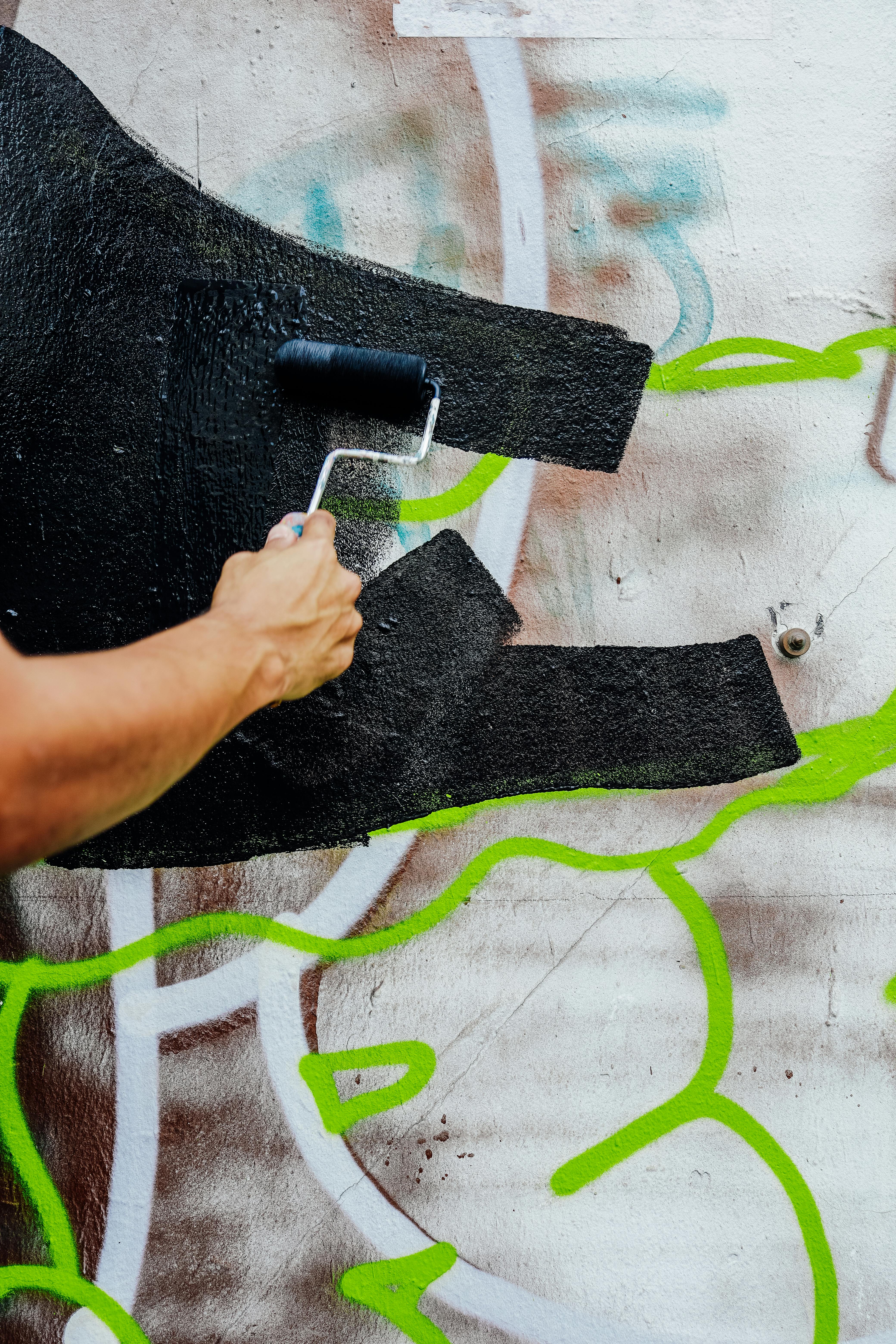 Painting Over Graffiti on Wall · Free Stock Photo