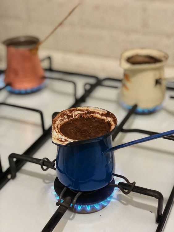 Free Close-up of Turkish coffee being brewed on a stove with copper pots. Stock Photo