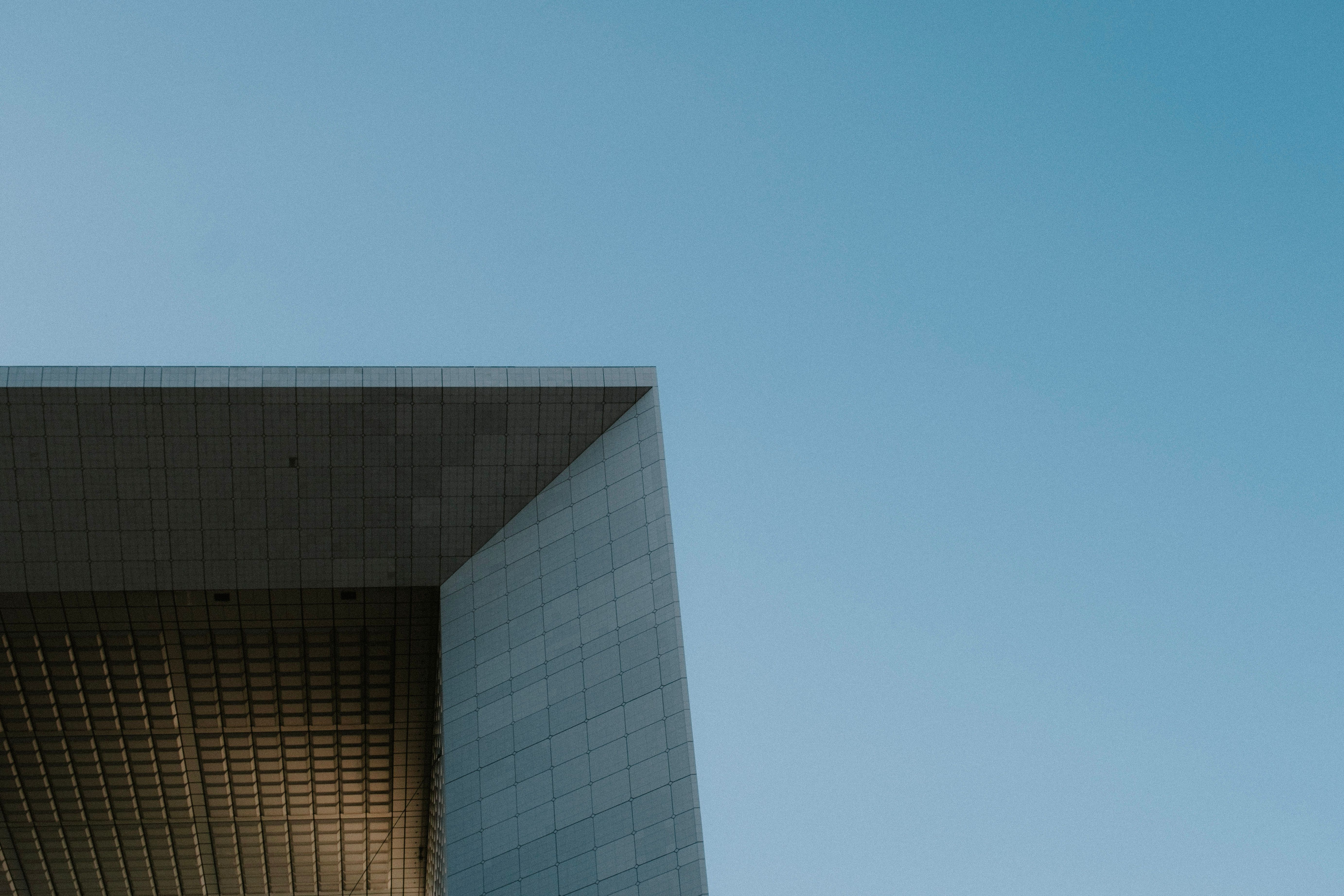 Modern architectural structure with a minimalist design against a clear blue sky.