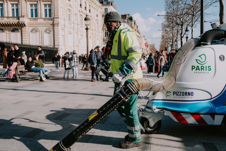 Man Cleaning Street With Blower