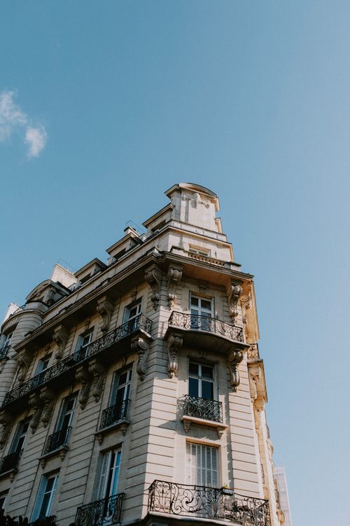 Free Low angle view of a classic Parisian building against a clear blue sky. Stock Photo