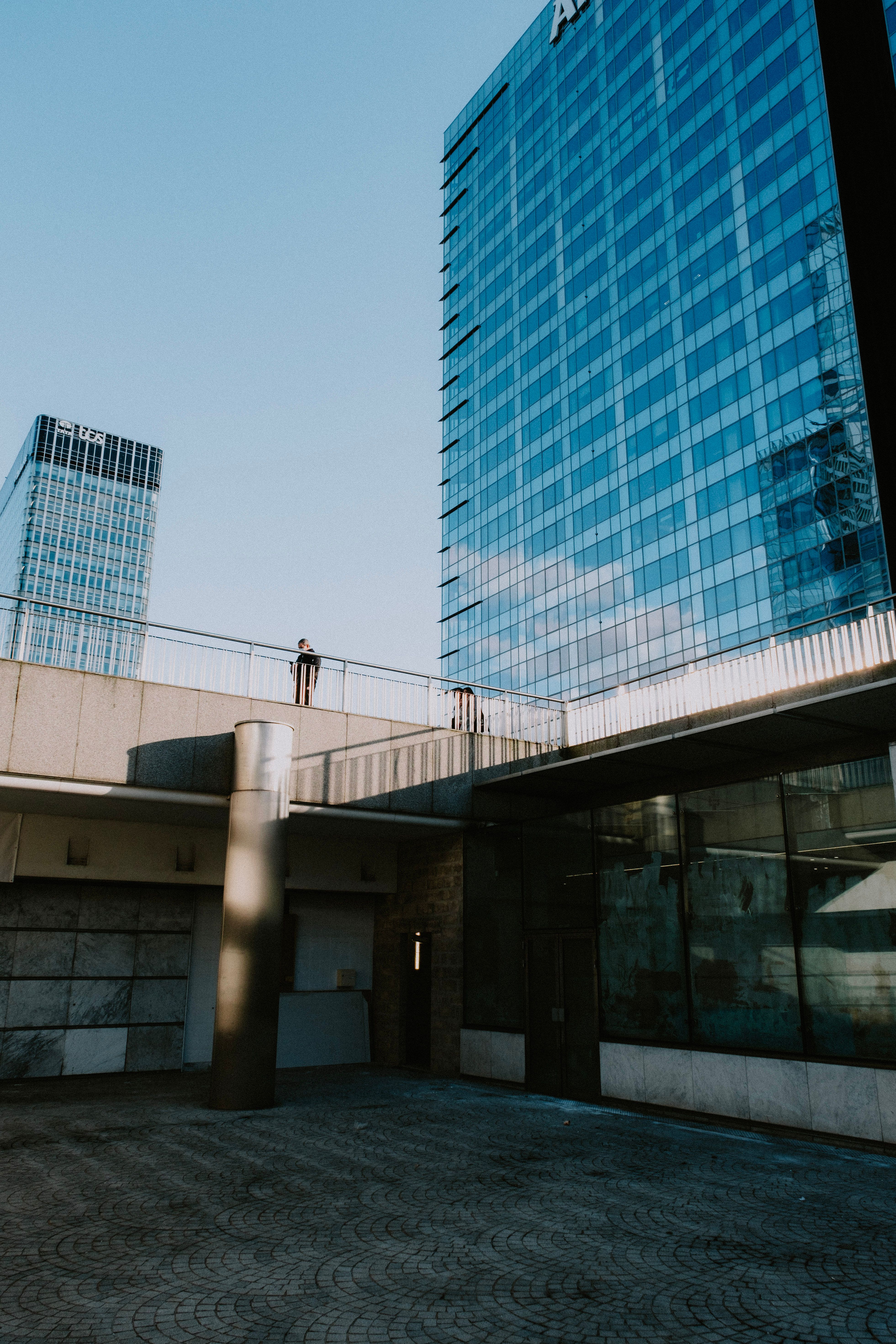A Glass High Rise Building Under Blue Sky · Free Stock Photo