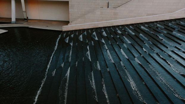 Elegant modern architecture featuring a cascading water design in an art setting.
