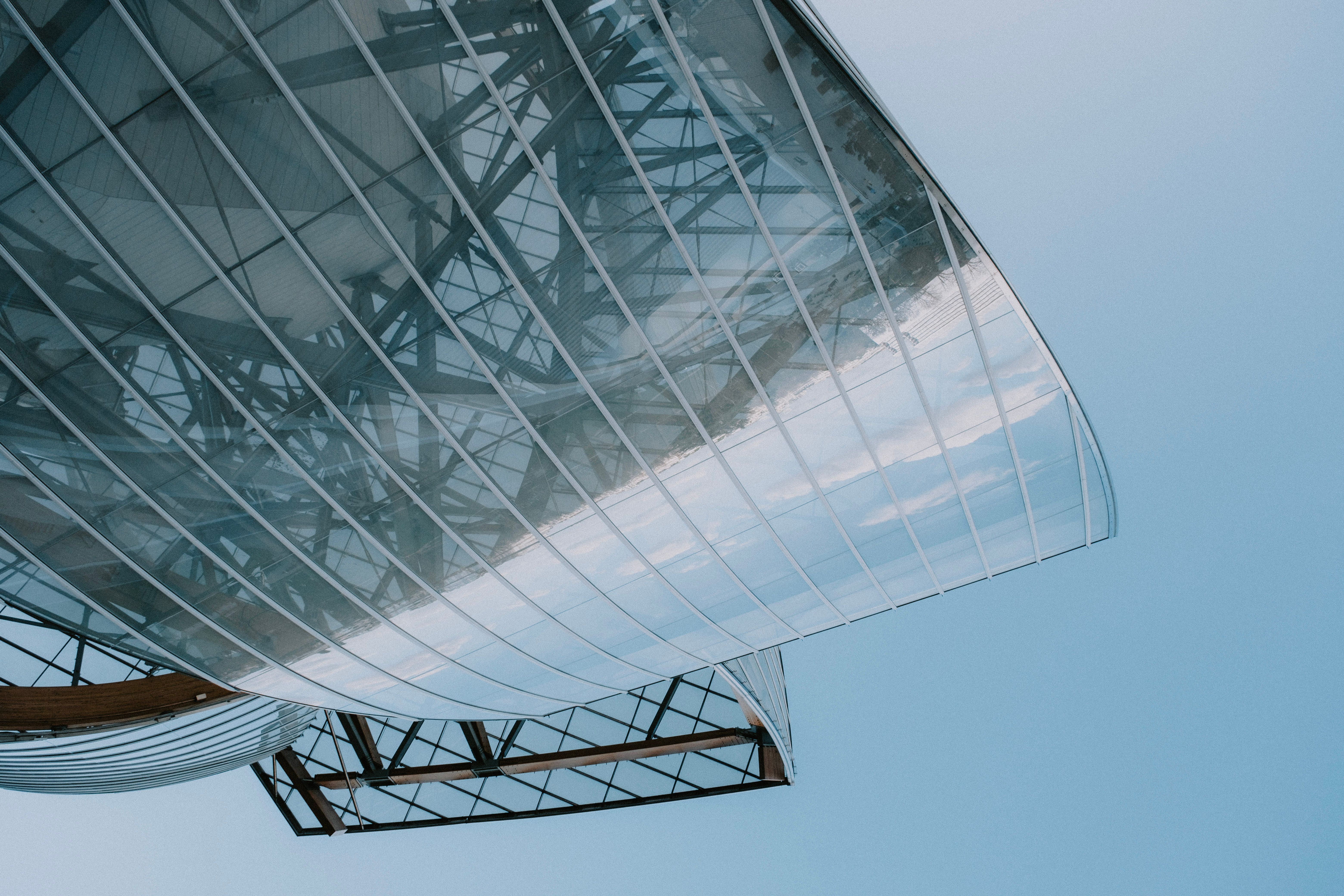 Low angle view of a modern glass facade showcasing contemporary architecture and design.