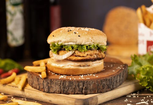 Hamburger and French Fries on a Wood Slab