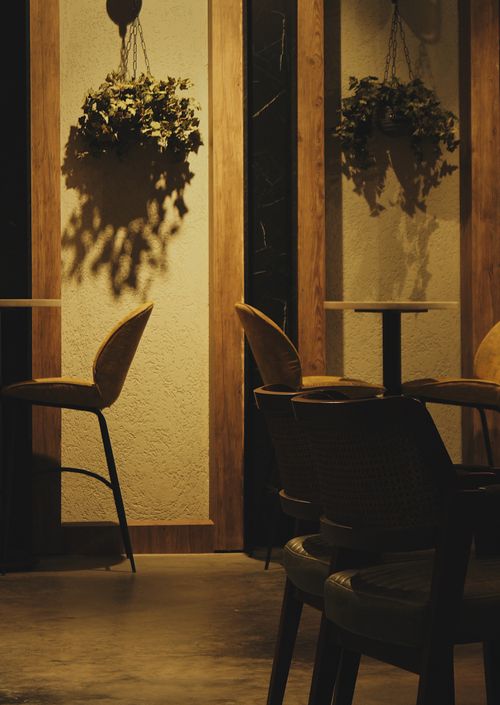 Free A warm and inviting seating area with elegant chairs and ambient lighting in a modern interior. Stock Photo