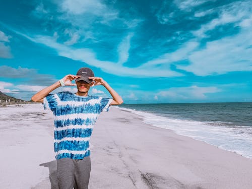 Man in Blue Shirt Standing on the Beach