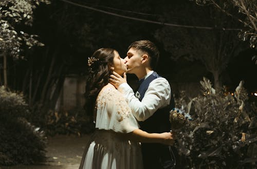 Free A Newly Wed Couple Kissing in the Garden Stock Photo