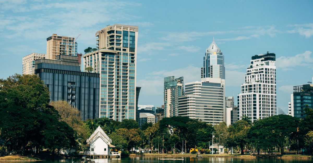 Bangkok skyline and lake at Lumphini Park.