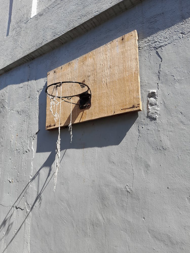 A Basketball Ring And Board Mounted On A Wall