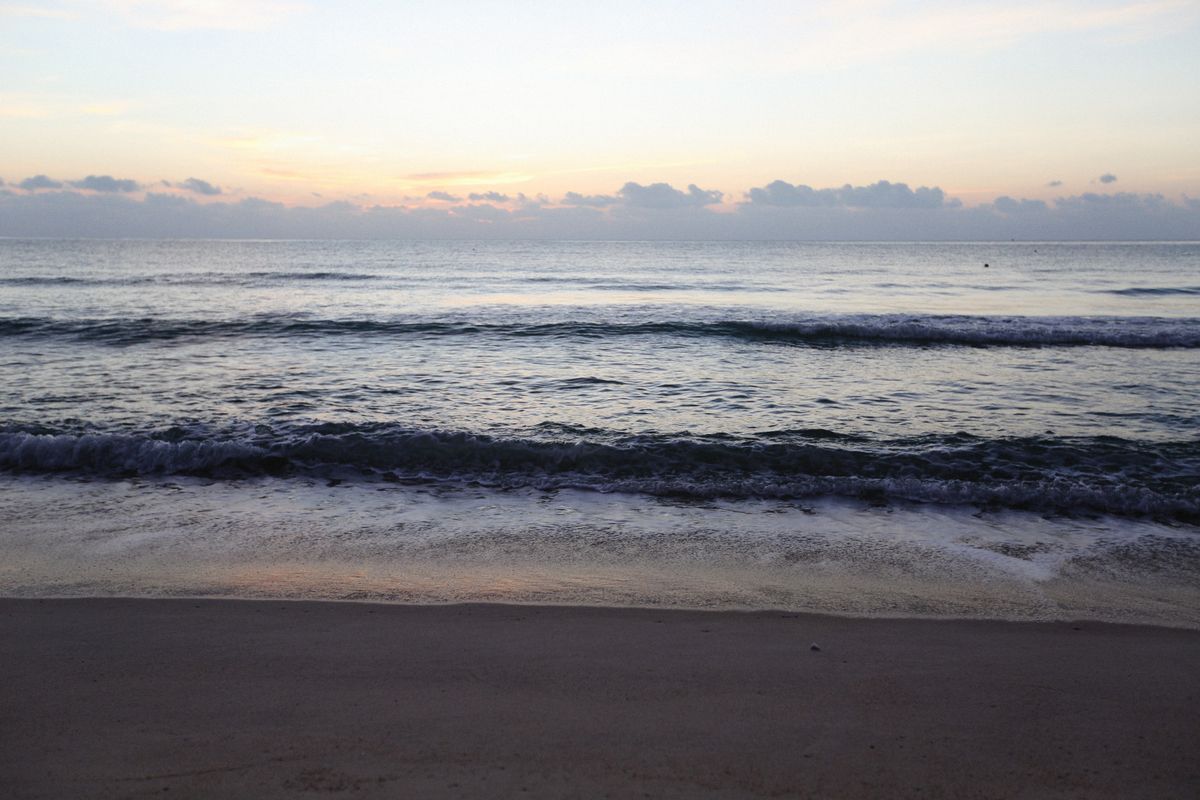 Pastel dawn over a still sea