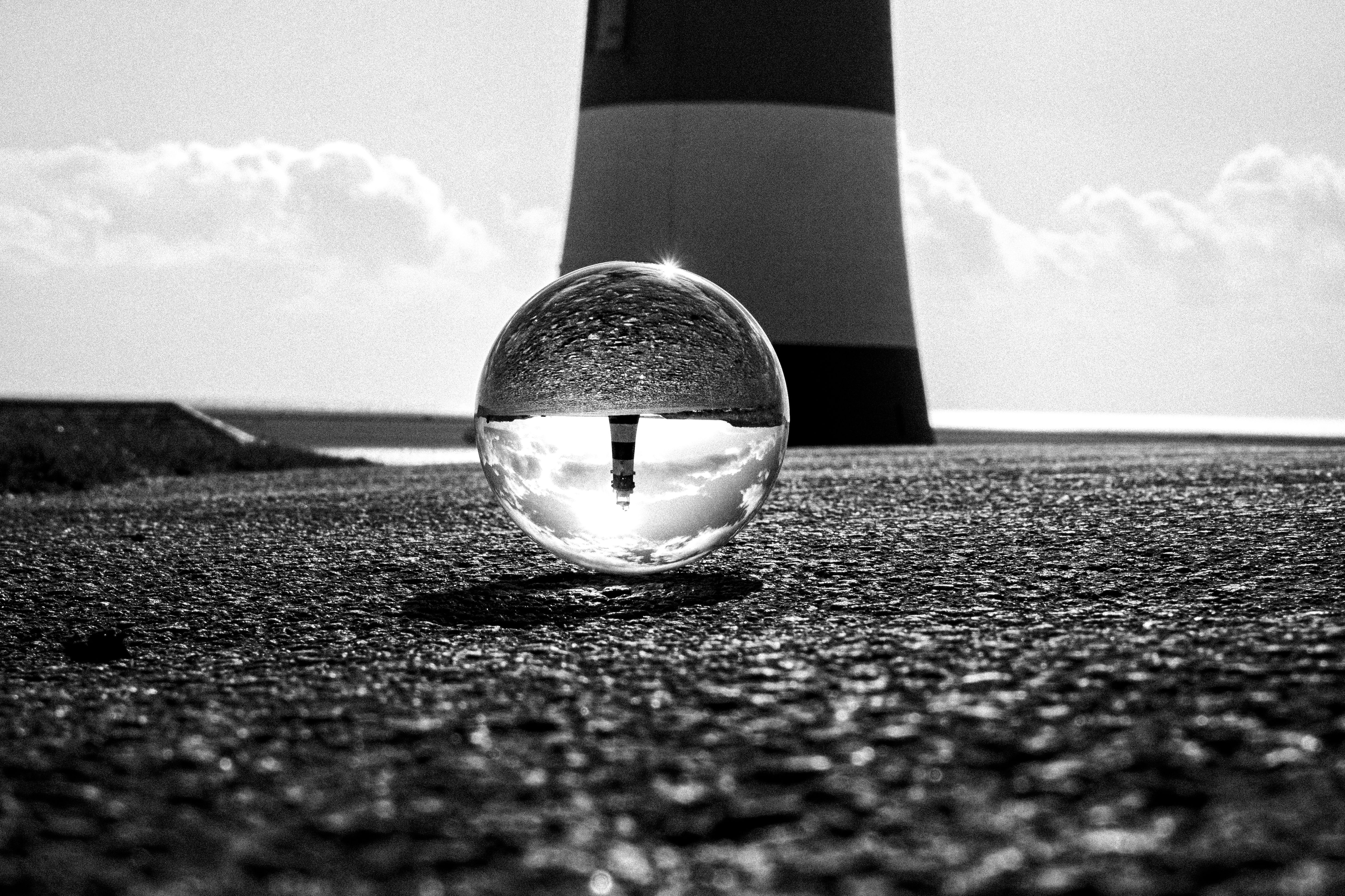 Lighthouse Ball A Grayscale of a Crystal Ball on the Ground with a Reflection of a ...