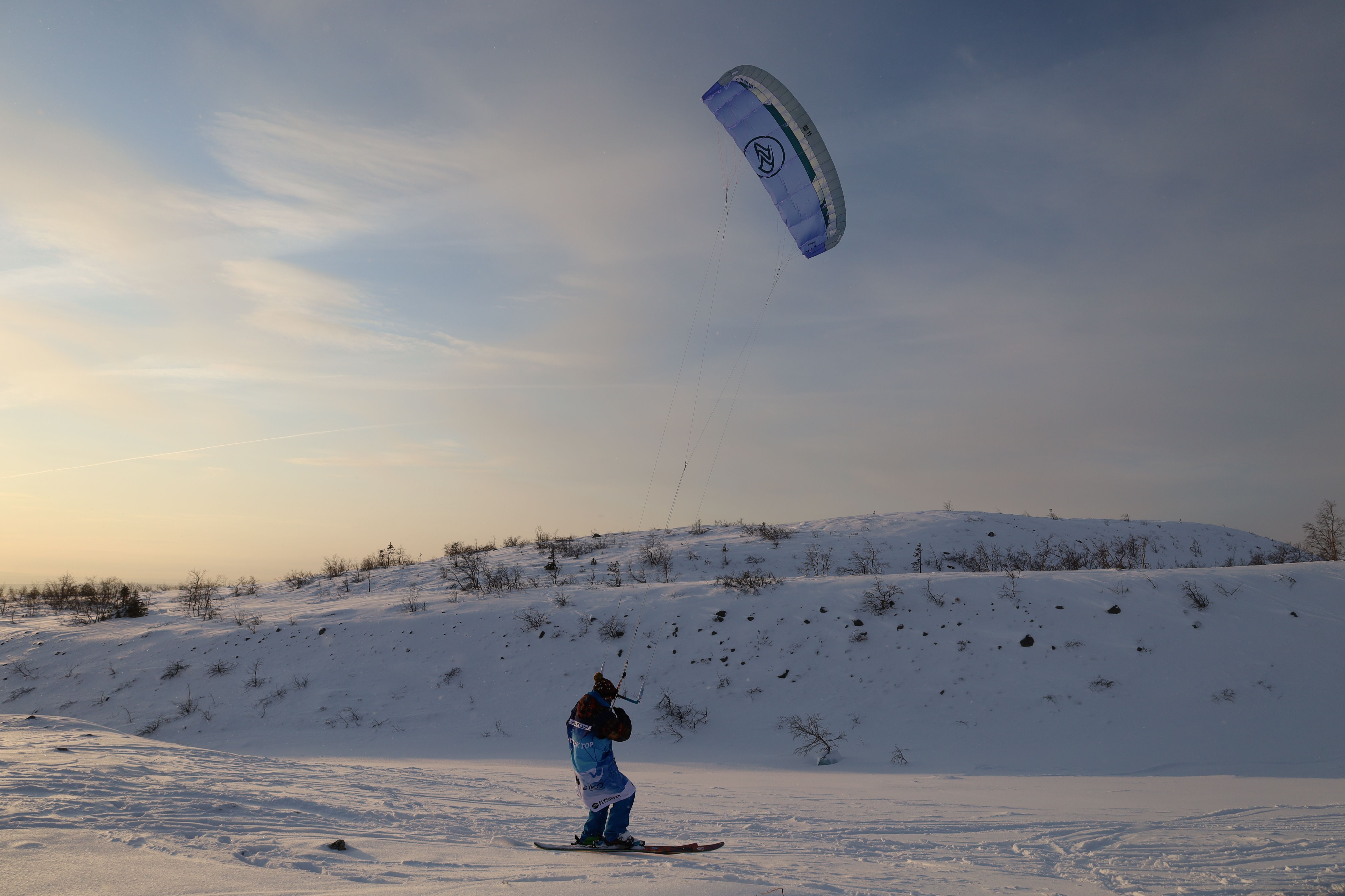 A Person Snowkiting on a Snow Covered Field · Free Stock Photo