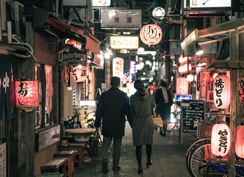 Couple Walking On Street At Night