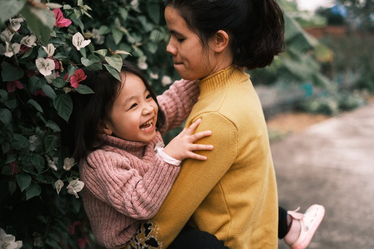 Sisters Playing In Garden