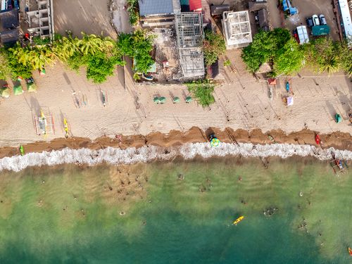 Free A vibrant aerial shot of a bustling tropical beach in the Philippines, perfect for summer travel inspiration. Stock Photo