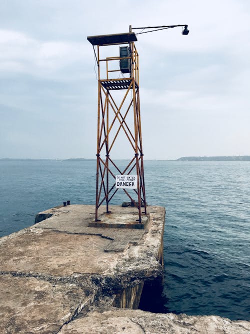 Watch Tower With Lamp Near Body of Water