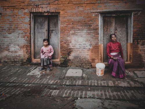 Woman and Girl Sitting at Doorstep