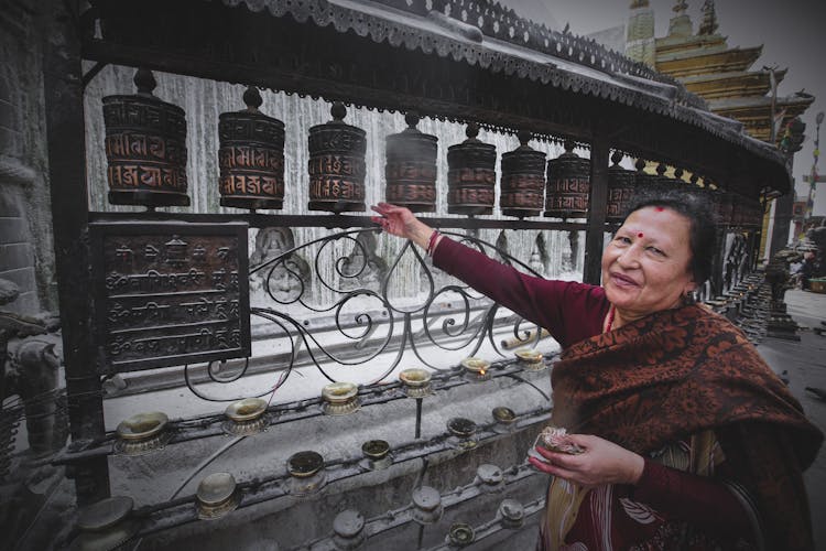 Old Woman Spinning Prayer Wheels