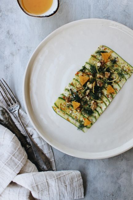 Appetizing zucchini salad elegantly arranged on a ceramic plate for gourmet dining.