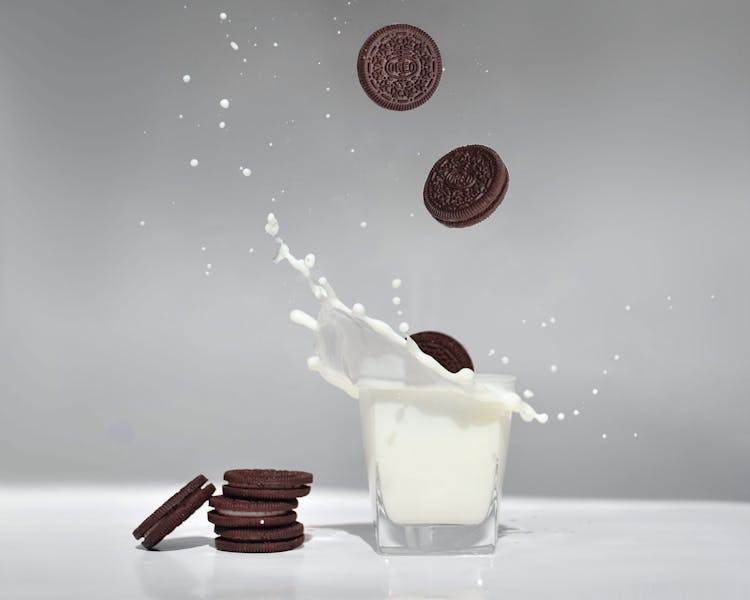 Cookies Falling Into A Glass Of Milk 