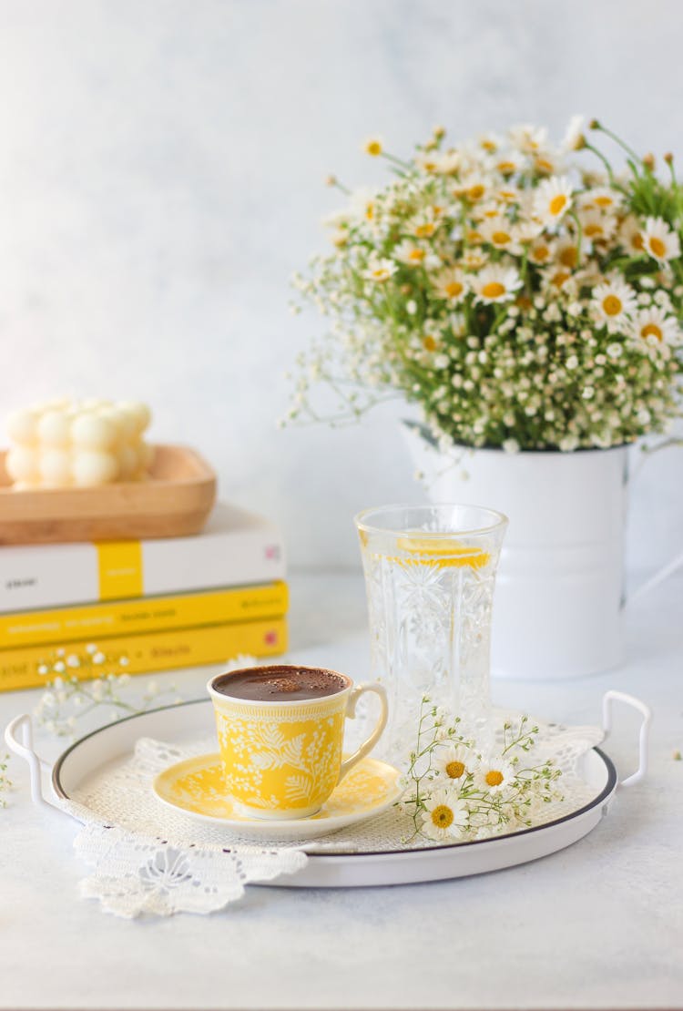 Black Coffee And Flowers On Table