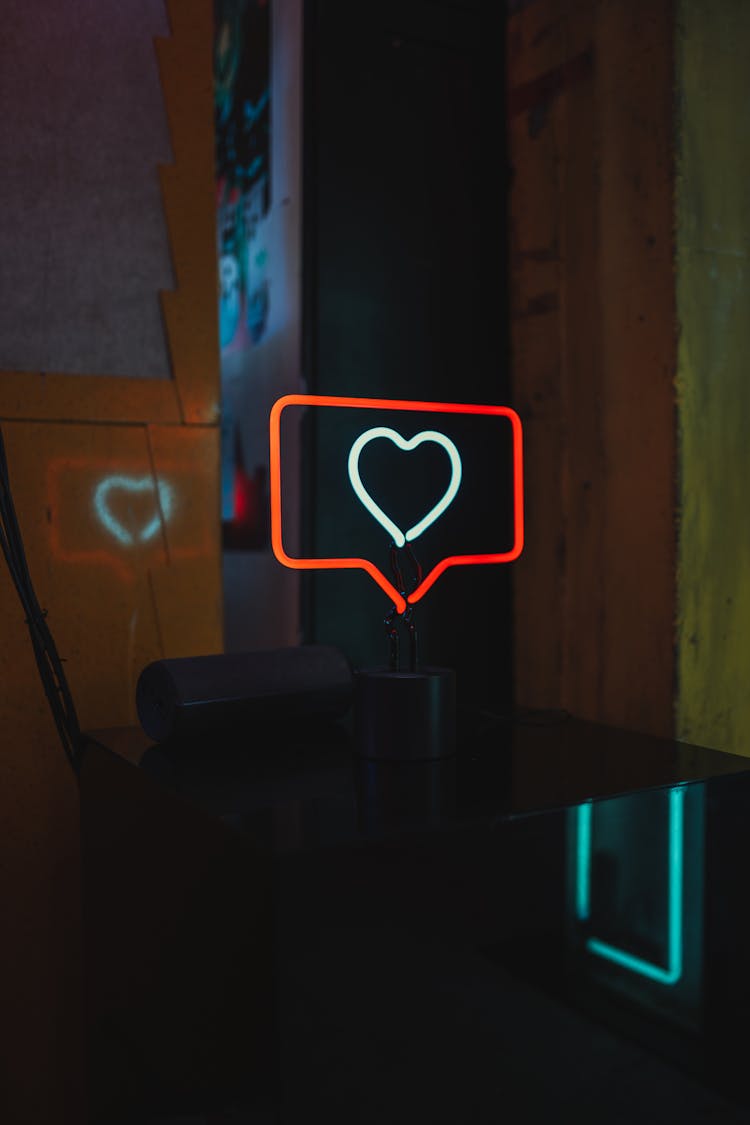 Red And White Neon Sign On A Table