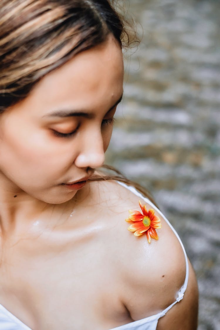 Woman With Flower On Her Shoulder