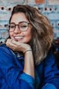 Closeup Photo of Smiling Woman Wearing Blue Denim Jacket