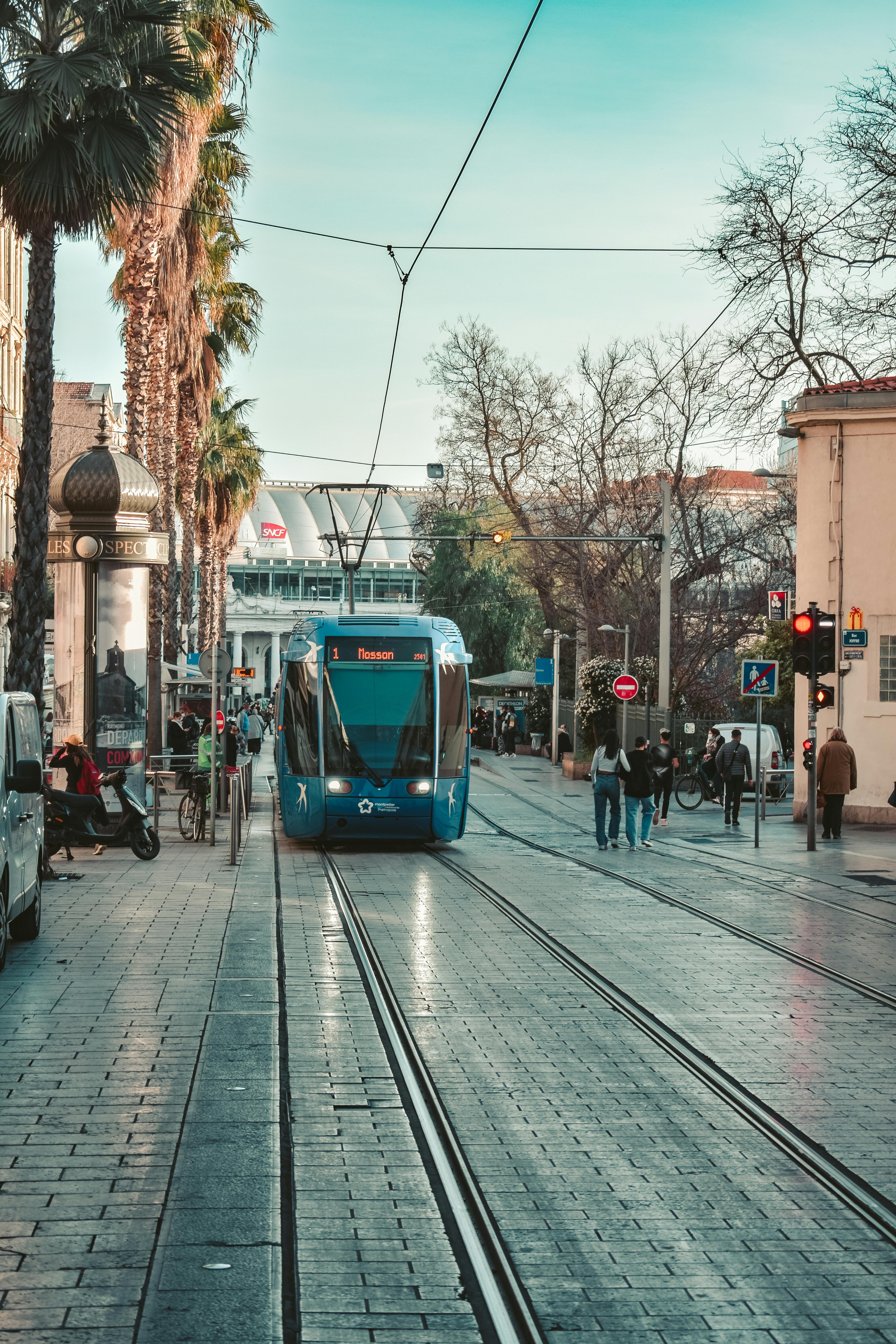 Free A vibrant street scene featuring a modern tram in Montpellier, France, amidst urban hustle. Stock Photo