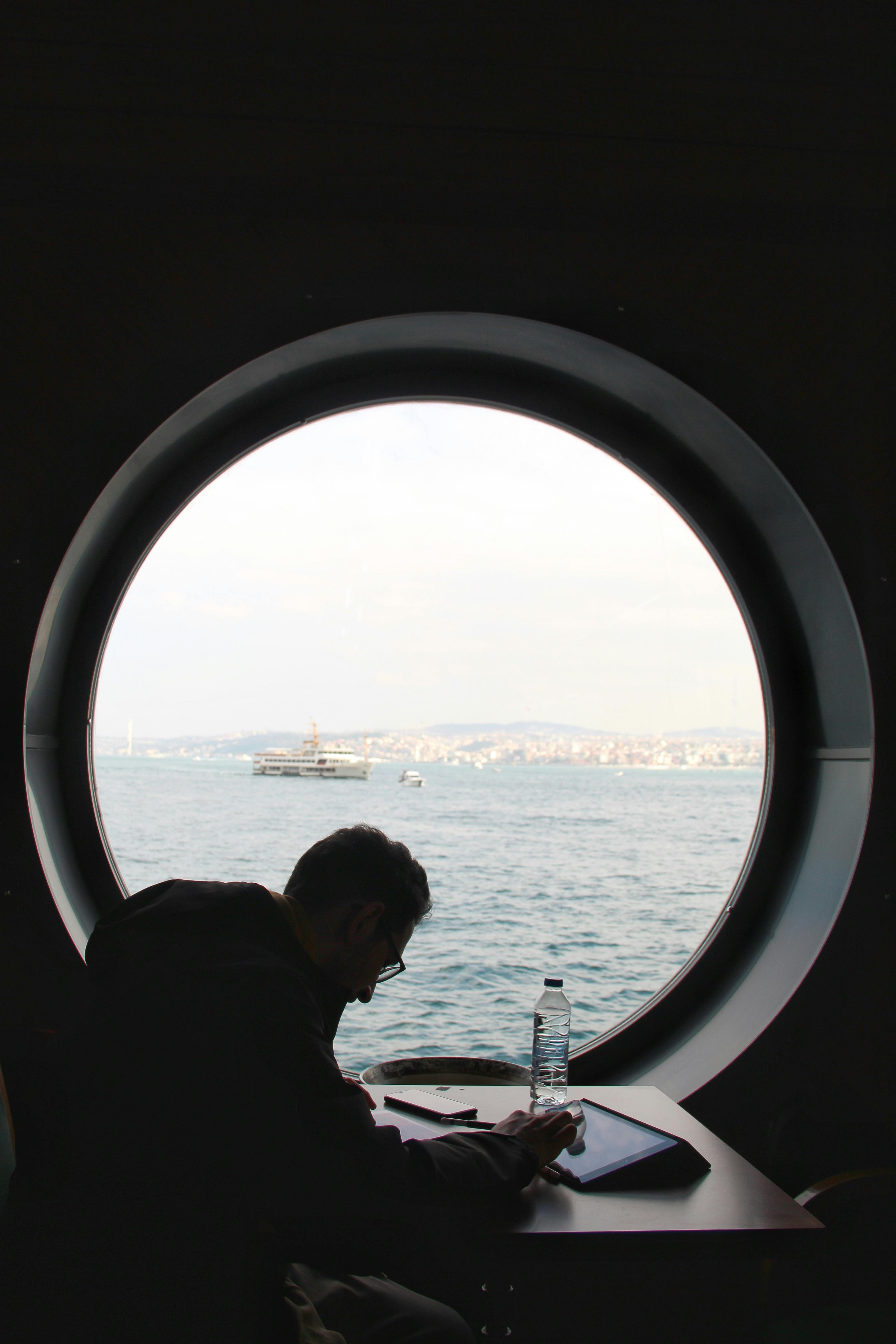 a man sitting beside the glass window