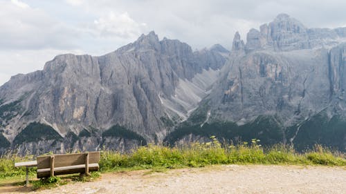 Brown Wooden Bench Near the Rocky Mountain