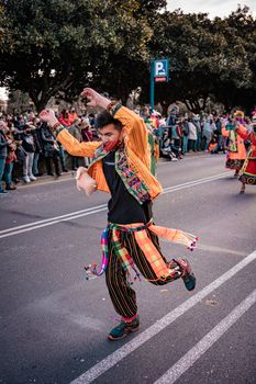 A lively festival parade in A Coruña featuring colorful costumes and dynamic dancers.