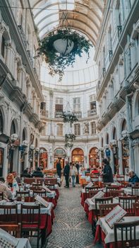 Elegant dining area inside an ornate historical building in Istanbul, Turkey, with people enjoying meals.