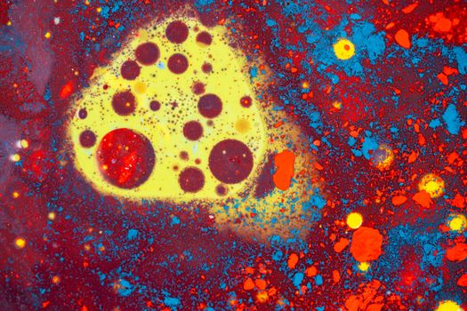 Colorful abstract fluid art composition with vibrant hues of red, blue, and yellow creating a dynamic pattern.