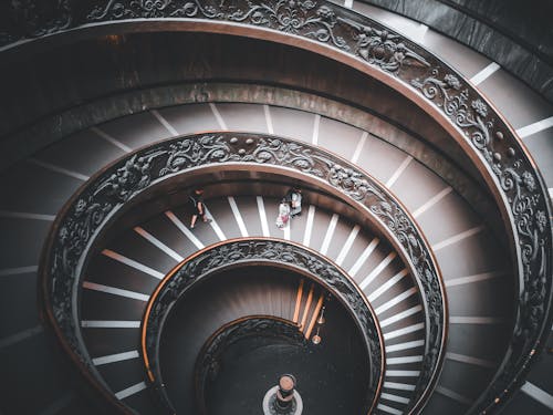 People Ascending Spiral Staircase