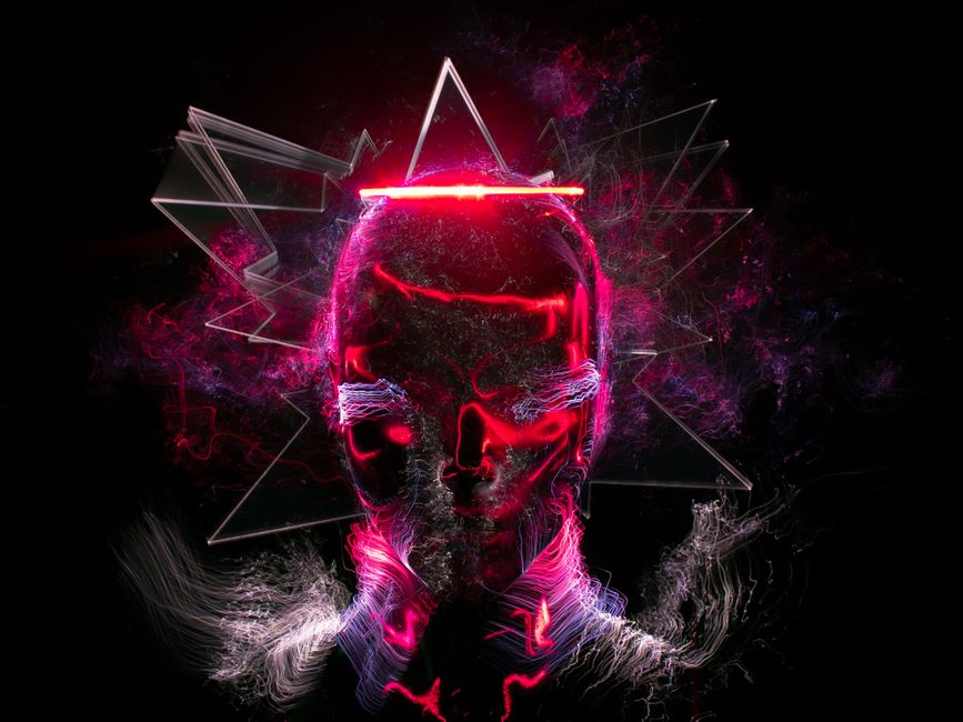 Digital artwork featuring a neon skull with vibrant abstract elements and light effects.