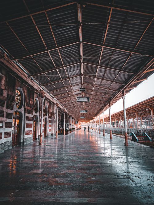 Free Empty vintage train station platform with historic architecture and moody lighting. Stock Photo