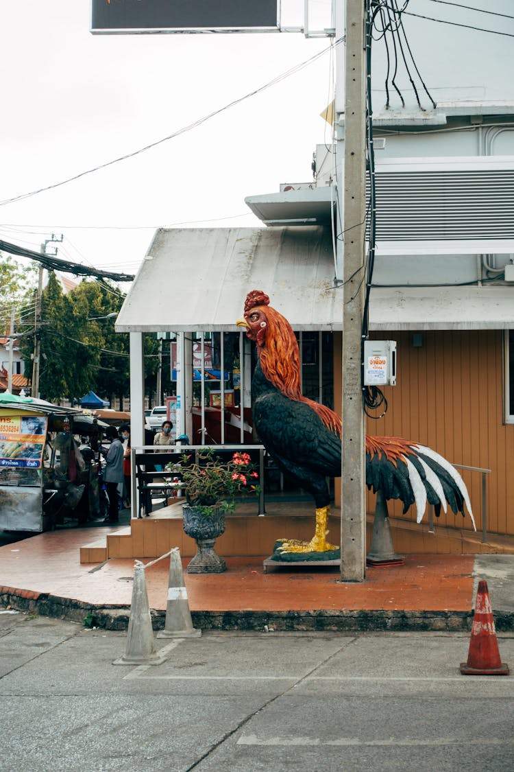 A Rooster Statue Outside Of A Restaurant