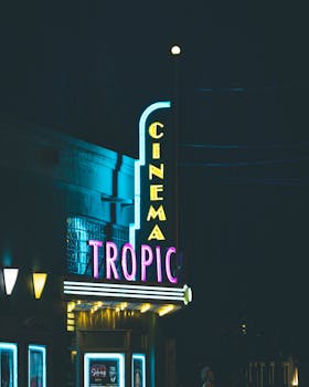 Vibrant neon sign of the Tropic Cinema in Key West, Florida, captured during night time.