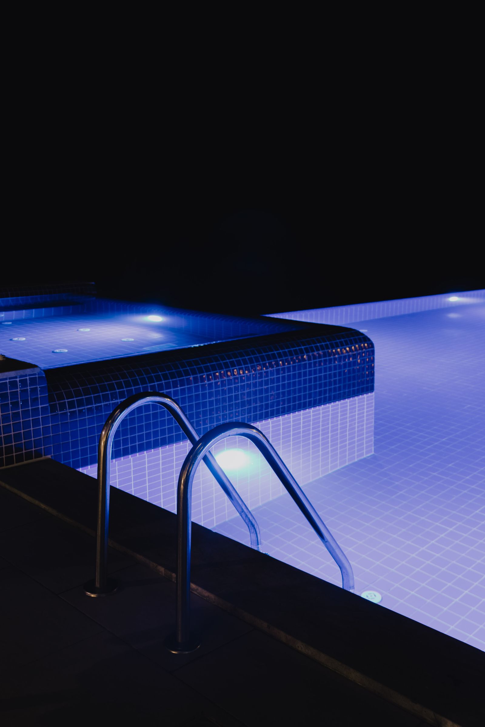 Backyard pool with night lighting