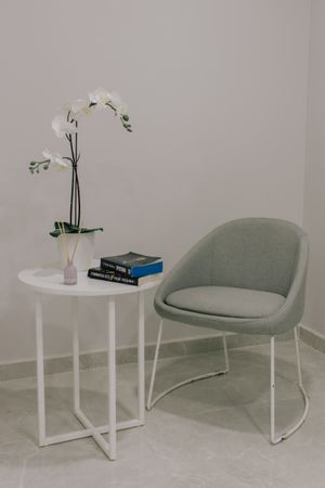 Modern interior with a minimalist grey chair by Ata Ebem on Pexels